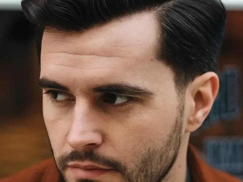 Side part low fade haircut for a young professional man in Queens