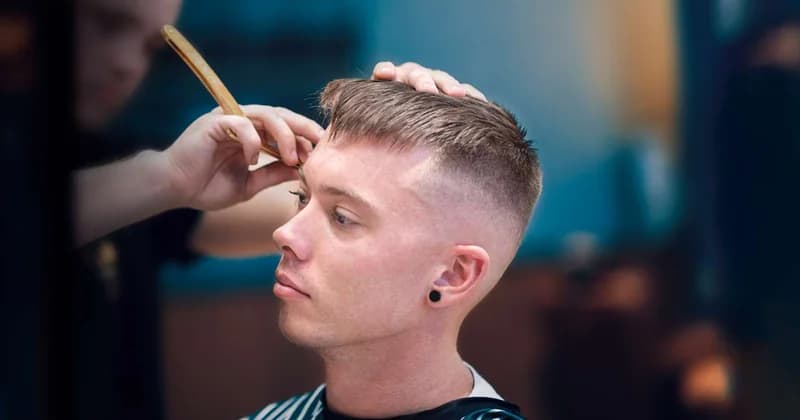 Textured crop fade haircut for men in their 20s in Queens NYC