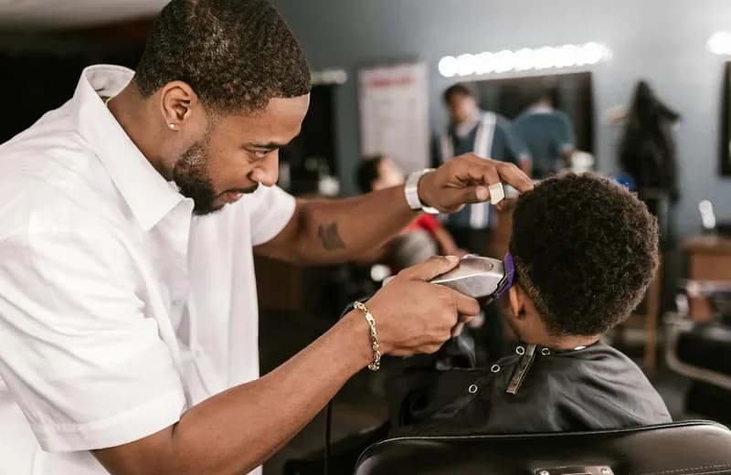 Professional Queens barber consultation for a man in his 20s choosing a modern haircut