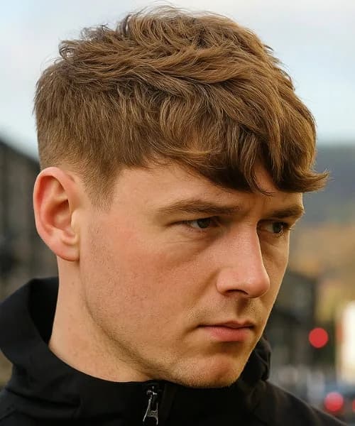 Short side-swept taper haircut for oblong face men