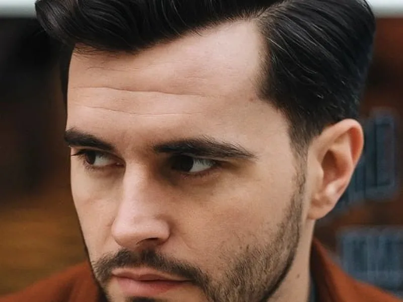 Side swept haircut for a diamond face man in Queens