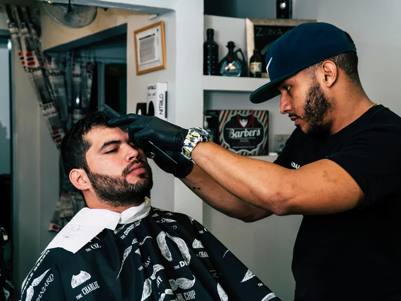Professional barber using clippers for a men’s haircut in Queens