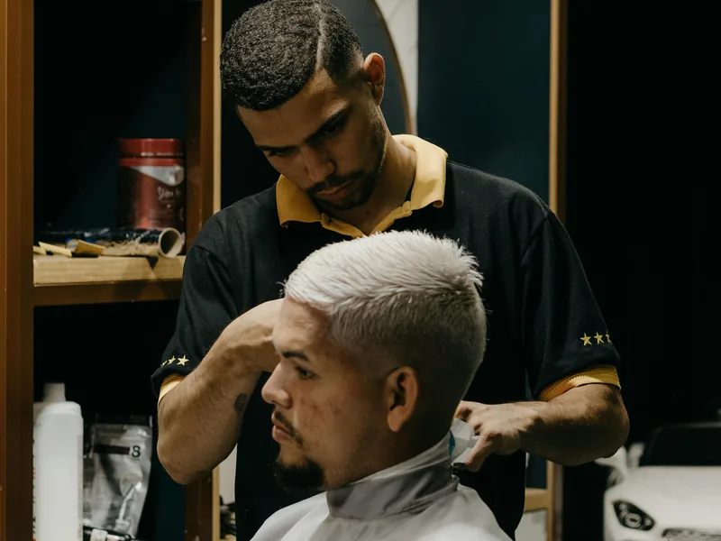 Professional Queens barber consultation and hair assessment before a haircut